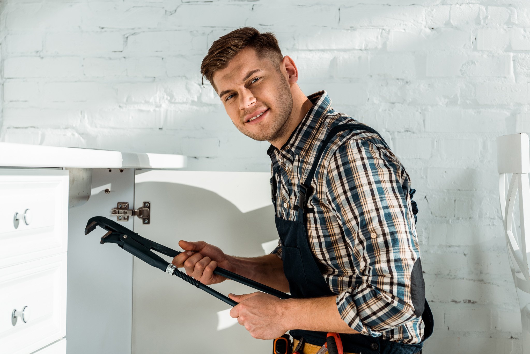 happy-installer-holding-slip-joint-pliers-while-wo-2023-11-27-05-14-32-utc-2